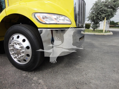 Front left view of a yellow Peterbilt 337 truck with chrome front bumper and wheel, rollback equipment visible, part of cab and fender.