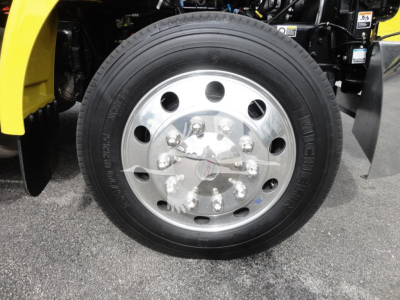 Peterbilt 337 wheel and tire close-up showing polished steel rim and hub with lug nuts.