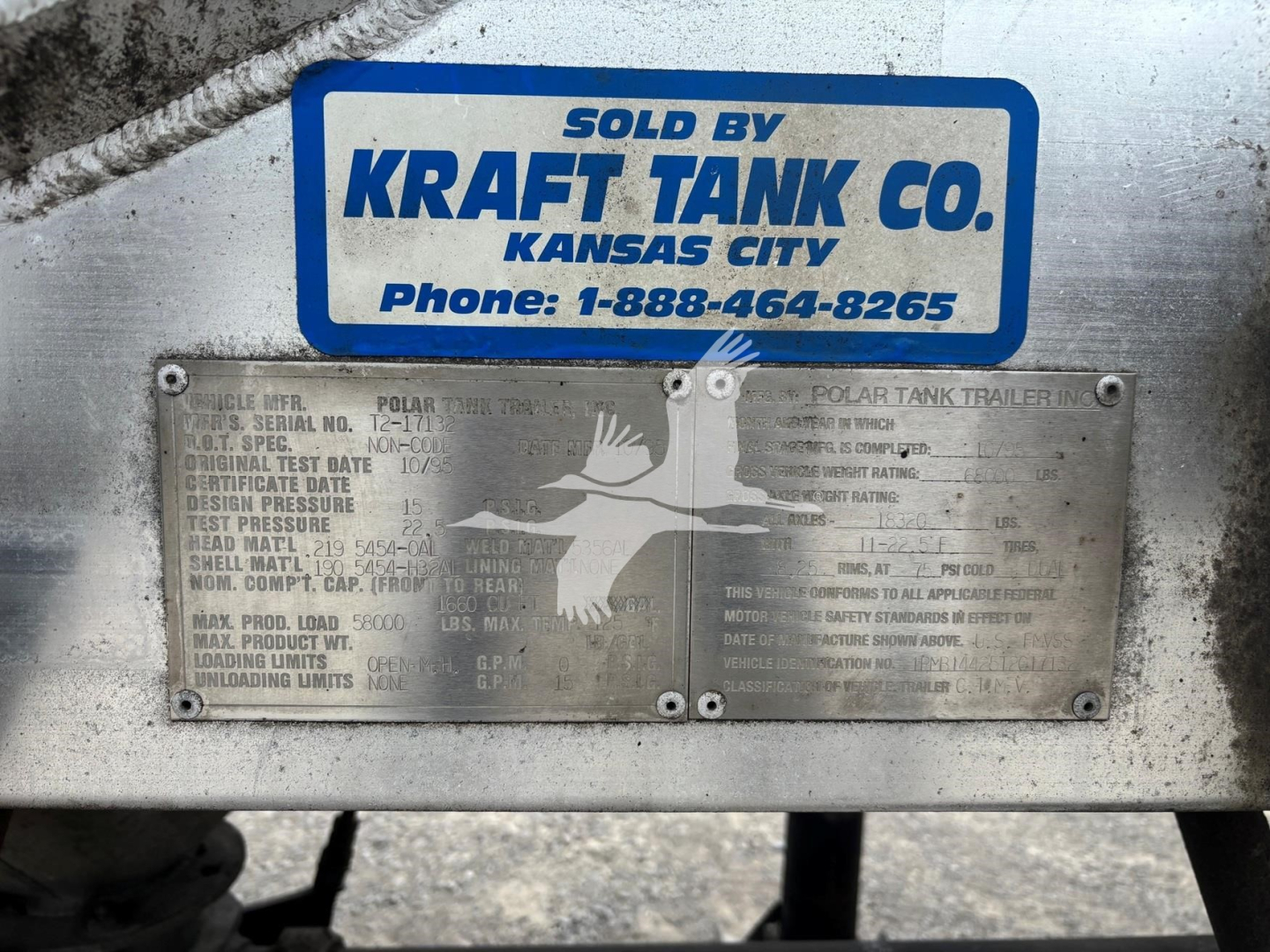 Plate with serial and DOT information on a Kraft Tank Co. trailer undercarriage with a blue Sold By Kraft Tank Co. sign plate and inspection plaque.