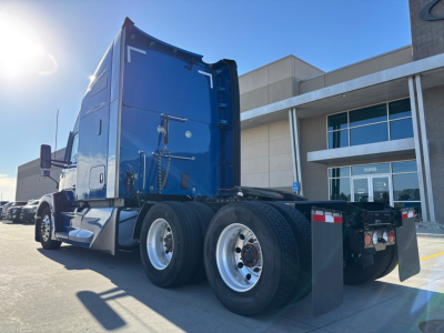 Kenworth T680 tractor rear view showing dual rear axles and fifth wheel mounting with blue cab.
