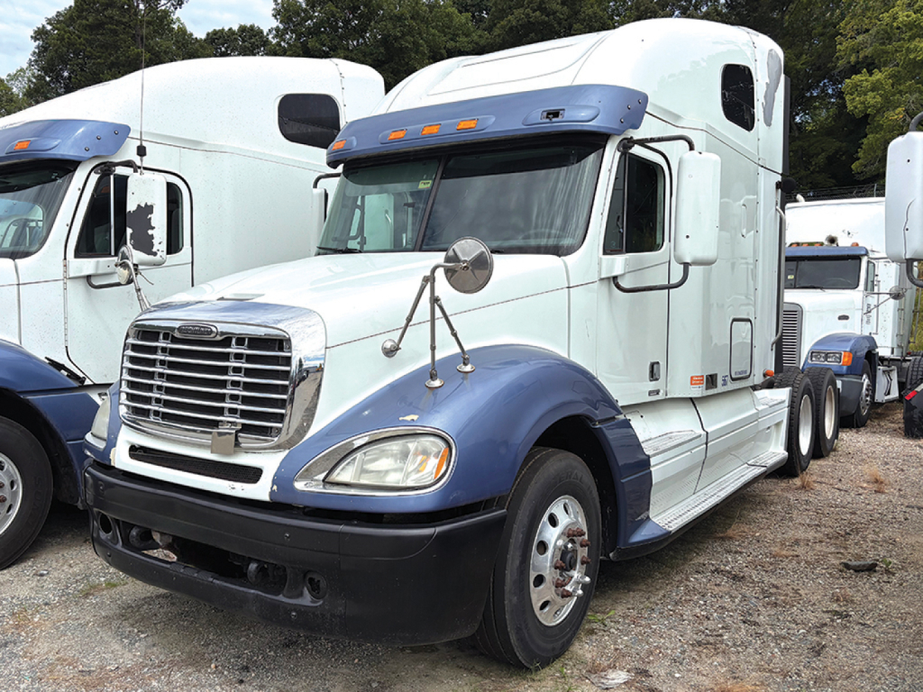 2012 Freightliner CL120 Columbia sleeper cab truck showing front grille, headlights, and blue/white color scheme.