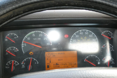 Dashboard of a Volvo truck showing multiple gauges and a central digital display with icons and text.