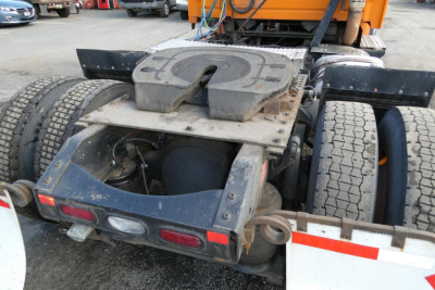 Rear view of a Volvo VNM truck chassis showing fifth wheel hitch and dual rear wheels with mud flaps and taillights.