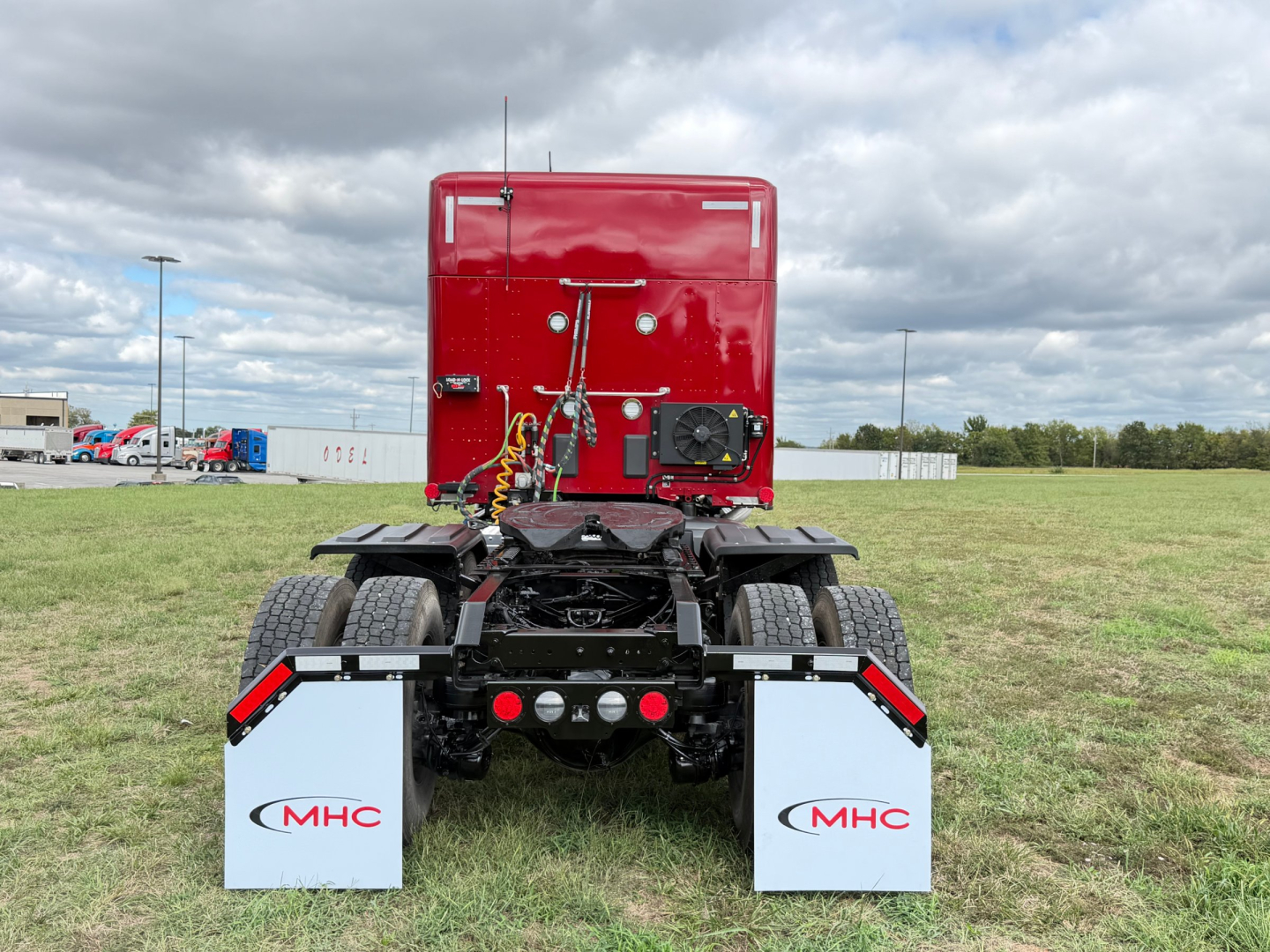 Kenworth T680 rear view showing chassis and mud flaps with MHC logos