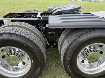 Kenworth T680 tractor rear with dual rear axles and chrome wheels; visible components and frame; no legible text on image