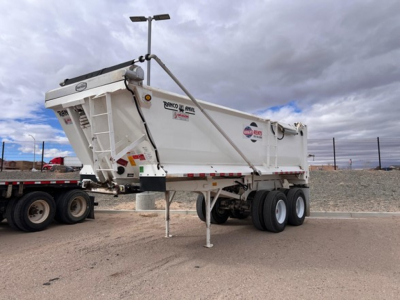 Trailer side view showing Ranco steel end dump with dual rear axles and hydraulic mechanism.