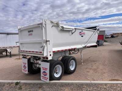 Dump trailer showing Ranco steel end dump with dual rear axles and white body, stock number 163753 visible on mudflaps.
