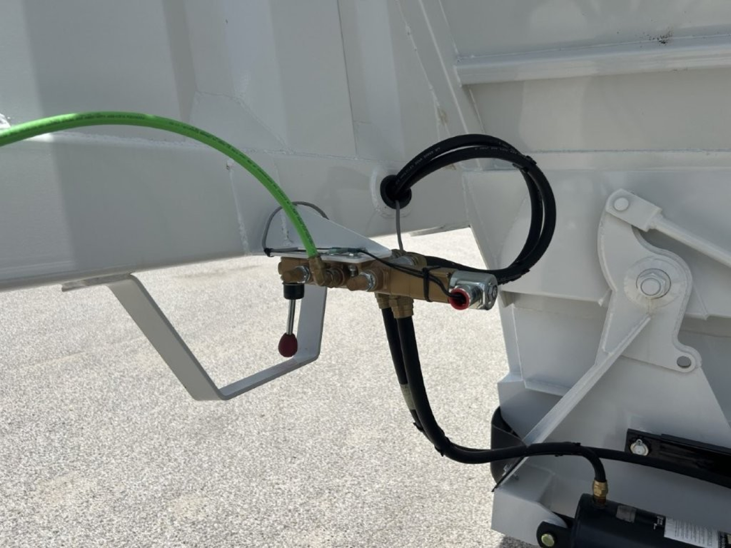 Trailer hitch area showing hydraulic hose and electrical cable connections on a CTS BDT-40 dump trailer