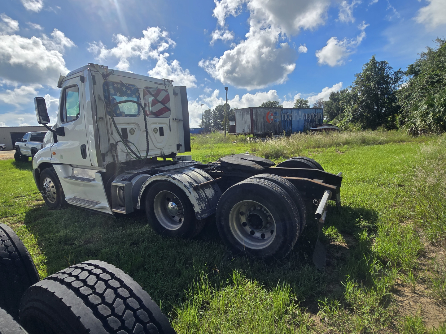 2017 Freightliner Cascadia 125 day cab truck chassis side view showing rear dual axles and tractor frame with wheels.