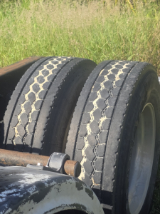 Dual rear truck tires with tread pattern visible on a Freightliner Cascadia 125 day cab — part of a used tractor-trailer.
