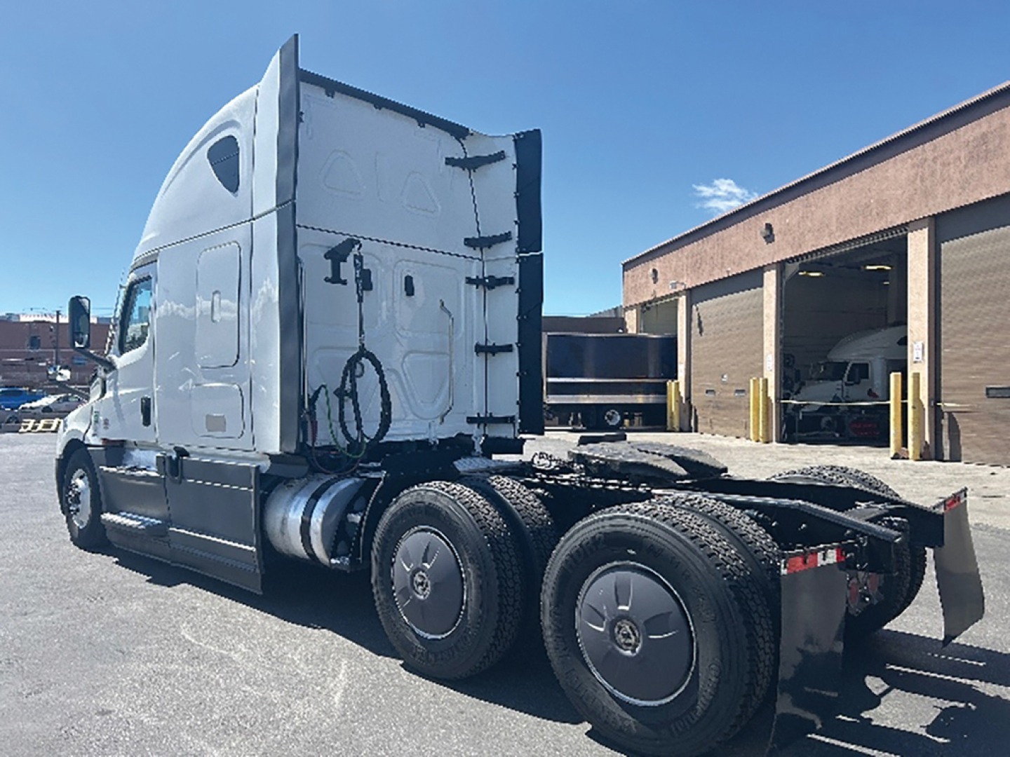 Freightliner Cascadia126 tractor side view showing sleeper cab, rear wheels, and chassis with fifth wheel area visible.