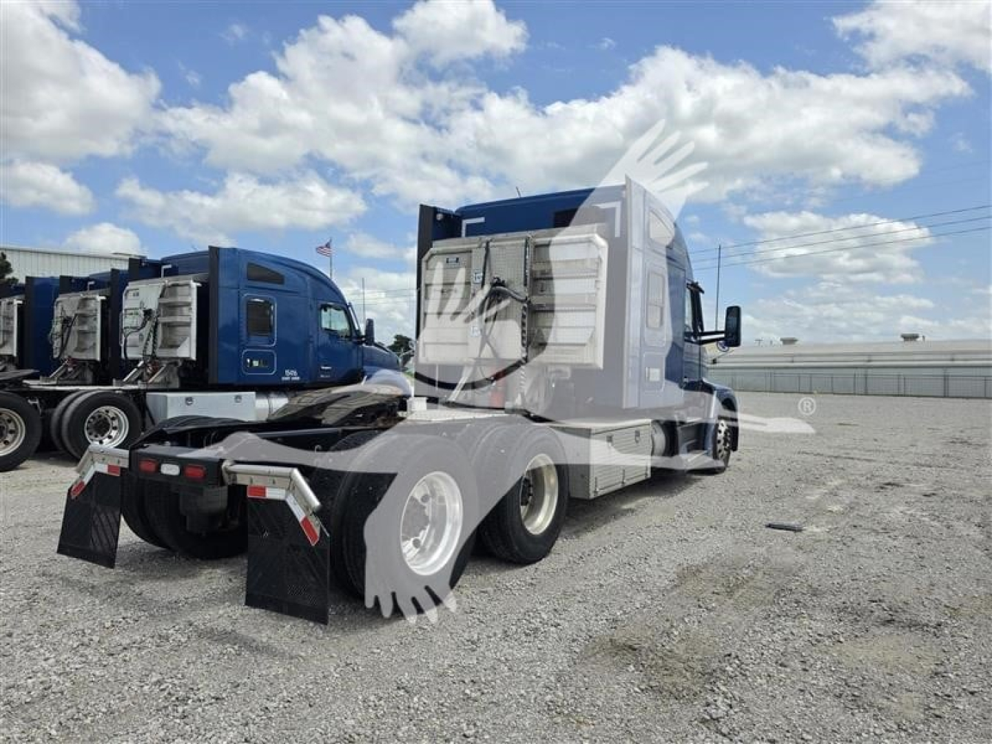 Kenworth T680 tractor in view from rear-left showing sleeper cab, tandem axles, and fenders with mud flaps; blue truck with chrome accents.