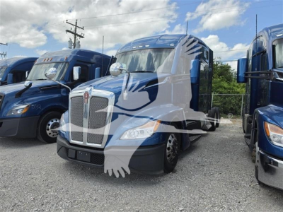Kenworth T680 truck in a lot showing front grille, headlights, and blue cab with sleeper model; vehicle information not visible.