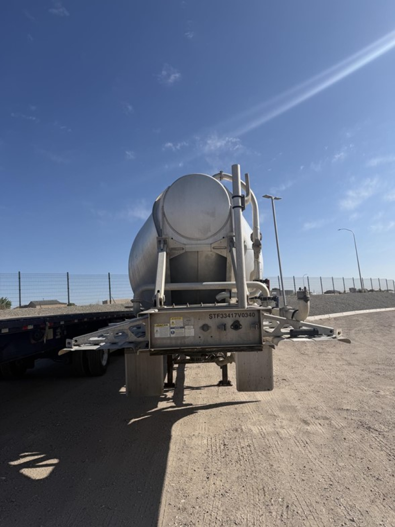 Heil pneumatic tank trailer rear view showing cylindrical tank and undercarriage with hitch and support beams.
