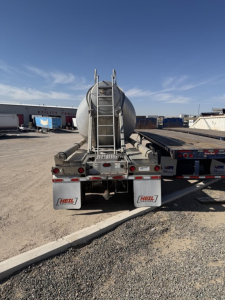 Rear view of a 2018 Heil Pneumatic Tank trailer showing ladder, tank, and rear hoses with HEIL branding on mud flaps.