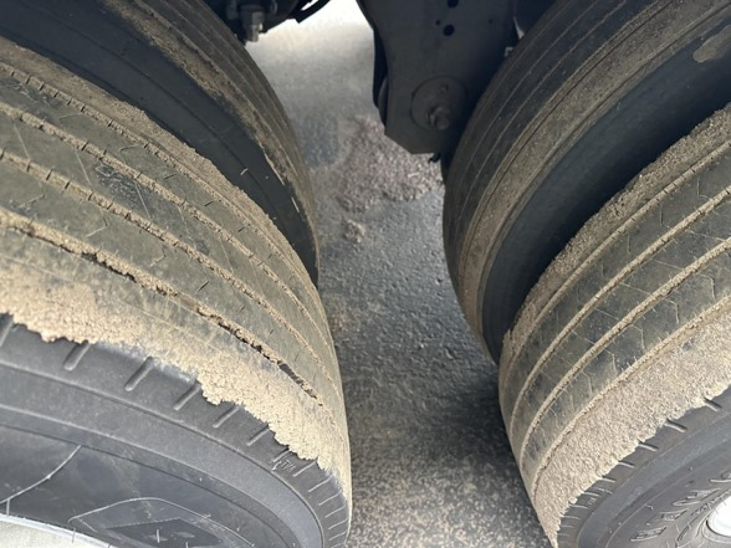 Dual rear tractor tires on a 2020 Utility 3000R trailer axle showing tread wear and road grime