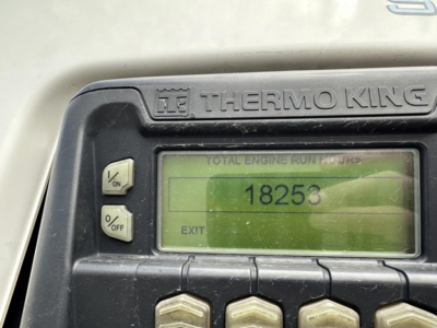 Truck engine monitor showing total engine run hours reading 18253 in a Thermo King unit with control buttons on left.
