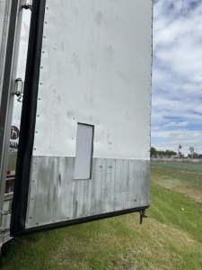 Rear corner of a 2020 Utility 3000R reefer trailer showing side panel, vent window, and lower metal trim.