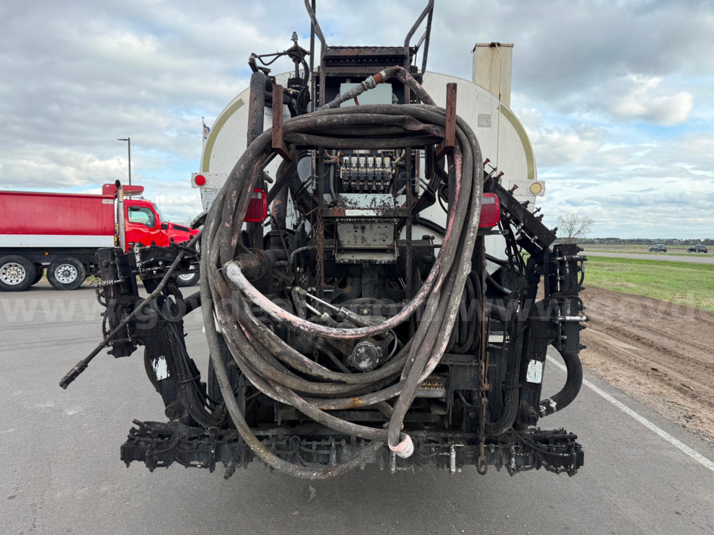 Bearcat asphalt hot oil truck rear view with hoses and hydraulic connections visible