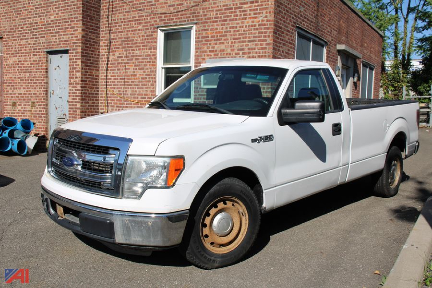 Ford F-150 pickup truck 2014 2WD white with long bed, front grille, single cab, plain steel wheels, in-service condition.