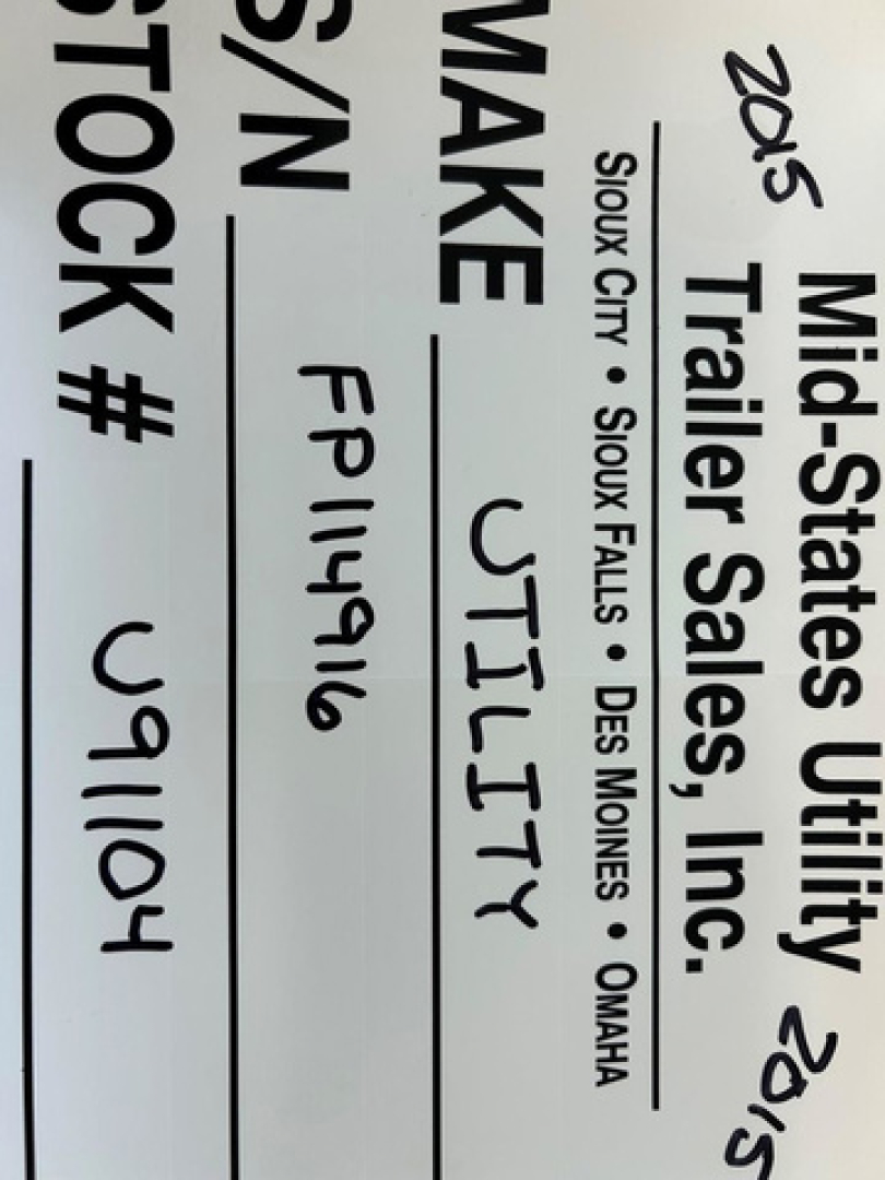Vertical trailer sign showing 'Mid-States Utility Trailer Sales, Inc.' and text: '2015' and 'Stock #' with handwritten 'FTLY' and 'FP1496' along with location list Sioux City, Sioux Falls, Des Moines, Omaha.