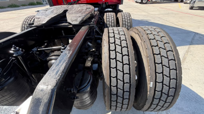 Kenworth T680 chassis showing dual rear axles with tires and suspension components; no cab, view of fifth wheel area and frame rails.
