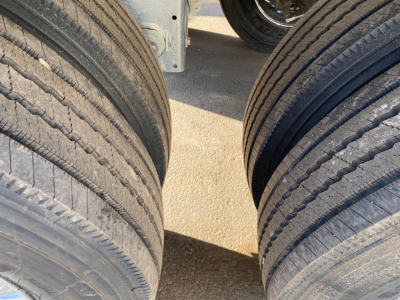 Rear view of a Mac Macsimiser trailer tires showing dual axle tires and part of the undercarriage.