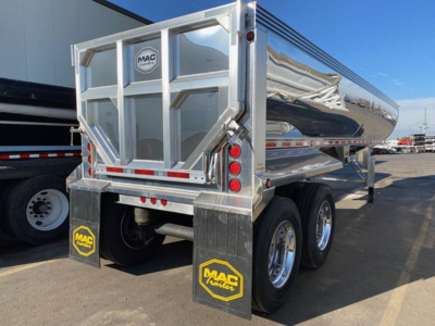 Macsimiser 1/2 round aluminum end dump trailer with air ride, rear view showing MAC Trailer logo on tailgate and polished aluminum side shells.