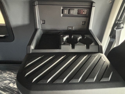 Dashboard and cab interior of a 2026 Mack PR64T76H truck showing a storage compartment and controls.