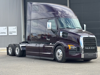 Mack PR64T76H Conventional Sleeper truck in dark maroon, 6x4 tractor, front grille with Mack badge, chrome bumper, side mirrors, two axles visible, cab with high sleeper, three rear axles.