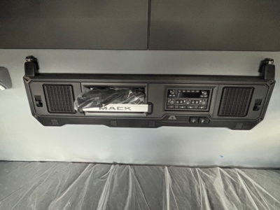 Mack dash panel with stereo, controls, and storage pocket; visible 'MACK' badge on the center handle.