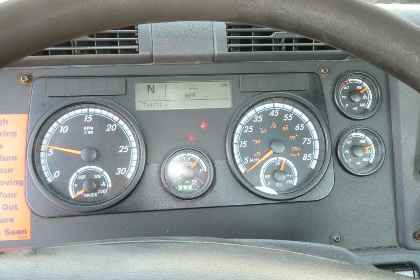 Dashboard of a 2017 Freightliner Cascadia 125, showing gauges and digital readout in a daycab truck cabin.