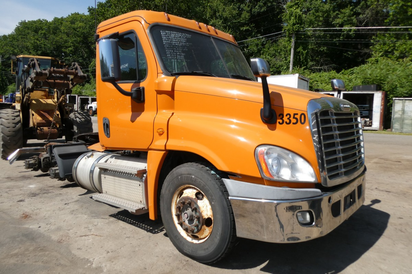 Orange Freightliner Cascadia 125 daycab truck side view showing cab, front grille, and wheel; number 3350 on hood.