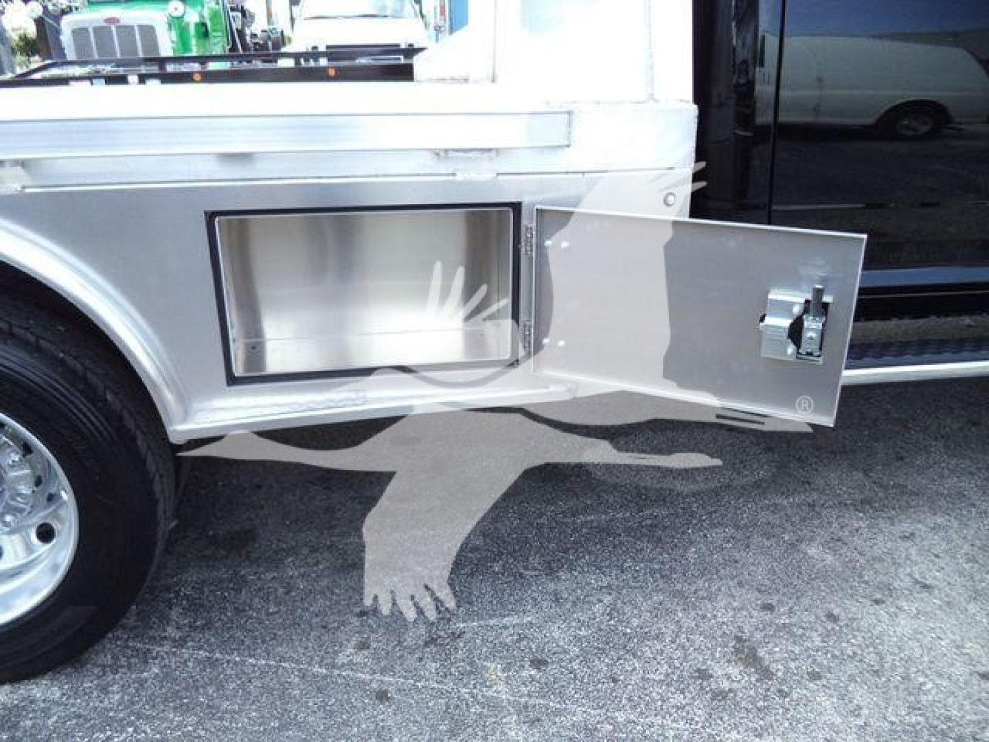 Ram 5500 flatbed side compartment door open showing storage box and latch