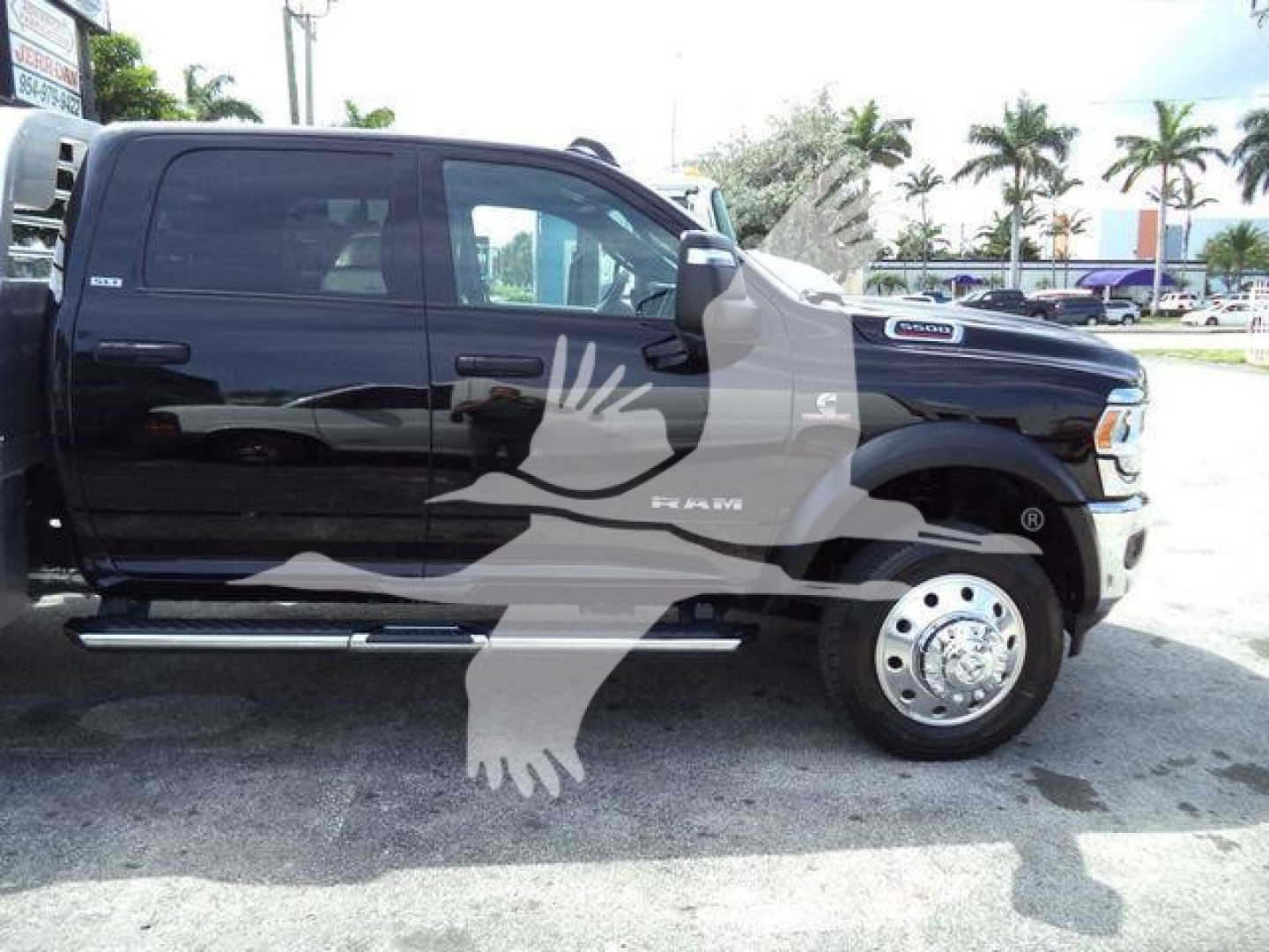 Ram 5500 truck side view showing crew cab and flatbed with chrome side steps.