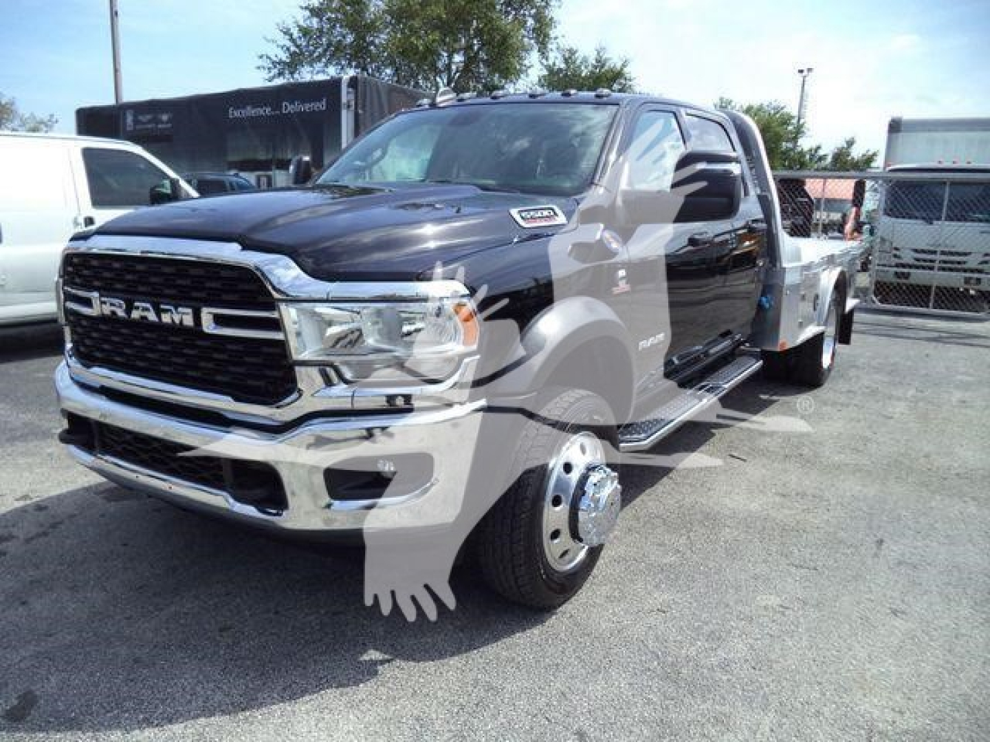 Ram 5500 SLT pickup truck in a dealership lot, front three-quarter view, black exterior, chrome grille, dual rear wheels on one side visible.