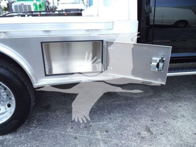Ram 5500 flatbed side compartment door open showing storage box and latch