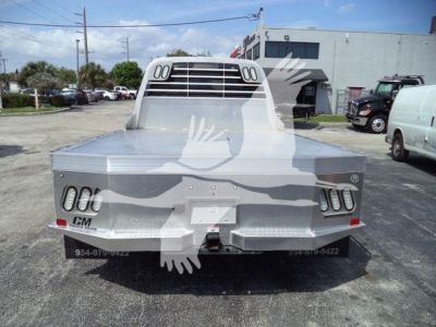 Ram 5500 flatbed truck rear view showing flat aluminum bed and tail lights
