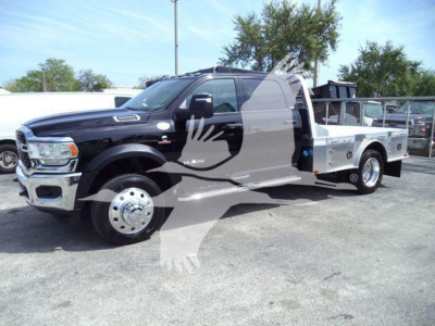 Ram 5500 SLT flatbed truck shown from side angle with long dual rear wheels and aluminum flatbed.