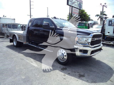 Ram 5500 SLT flatbed truck in black and chrome front view showing RAM grille and F-Series badge.