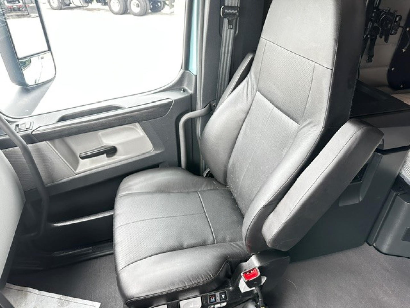 Freightliner Cascadia 126 truck interior driver seat and door area visible in cabin