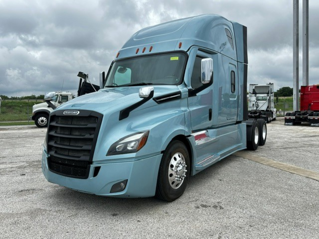 Truck showing 2023 Freightliner Cascadia 126 sleeper with front grille and headlights; blue exterior.