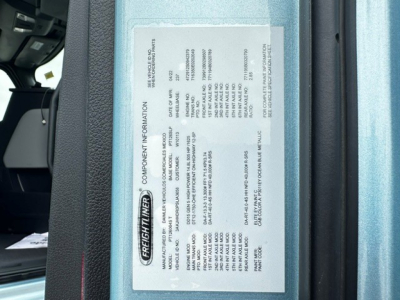 Freightliner CASCADIA 126 engine/badge label showing component information and serial data.