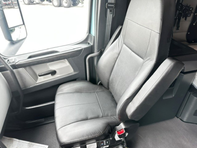 Freightliner Cascadia 126 truck interior driver seat and door area visible in cabin