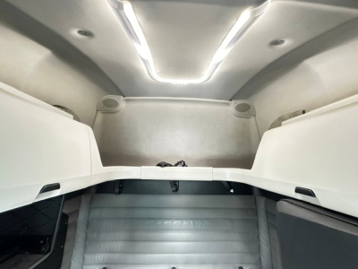 Cab interior of a 2023 Freightliner Cascadia 126 sleeper showing overhead bunks and interior panels.