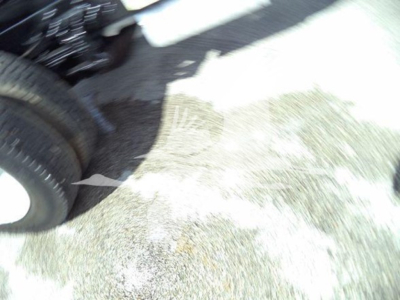 Truck wheel area and part of chassis visible; no legible text or labels.
