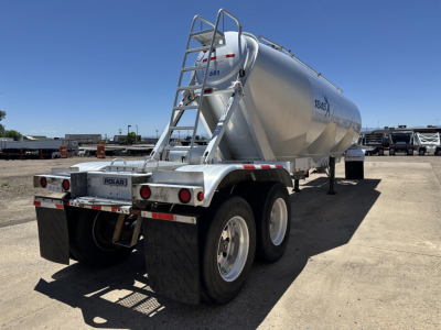 Tank trailer showing Polar 1000 Cu Ft gravity drop pneumatic air ride with dual rear axles and ladder on rear, silver cylindrical tank, VIN 150120756416.
