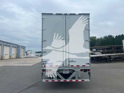 Rear view of a Vanguard sheet/post trailer with a graphic of two white birds in flight on gray doors, reflective tape along bottom edge, and license plate area in center.
