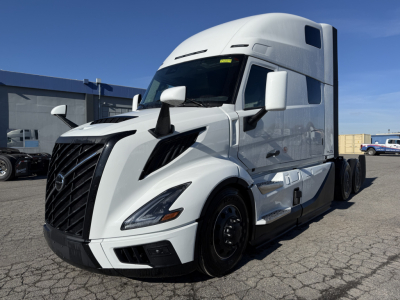 Volvo VNL64T860 sleeper cab tractor in white, front three-quarter view showing grille, headlights, and aerodynamic mirrors.