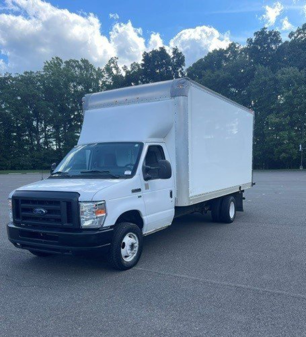 Truck cab chassis with box on back showing a white Ford E-Series Cutaway cargo body in a parking lot.